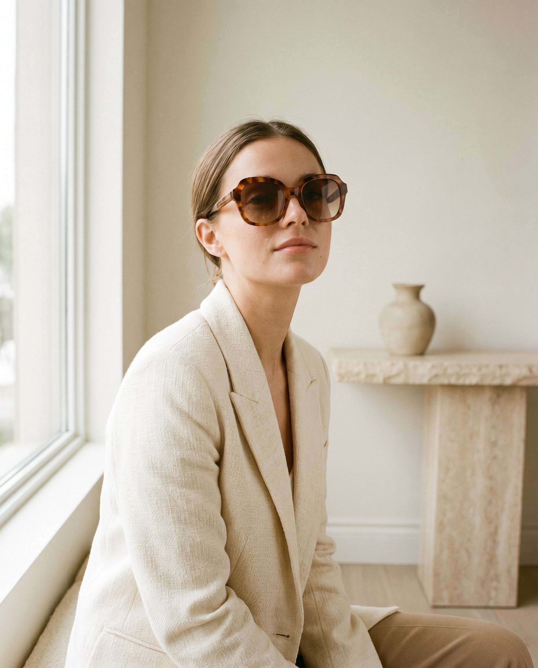 Woman wearing sunglasses in warm natural light