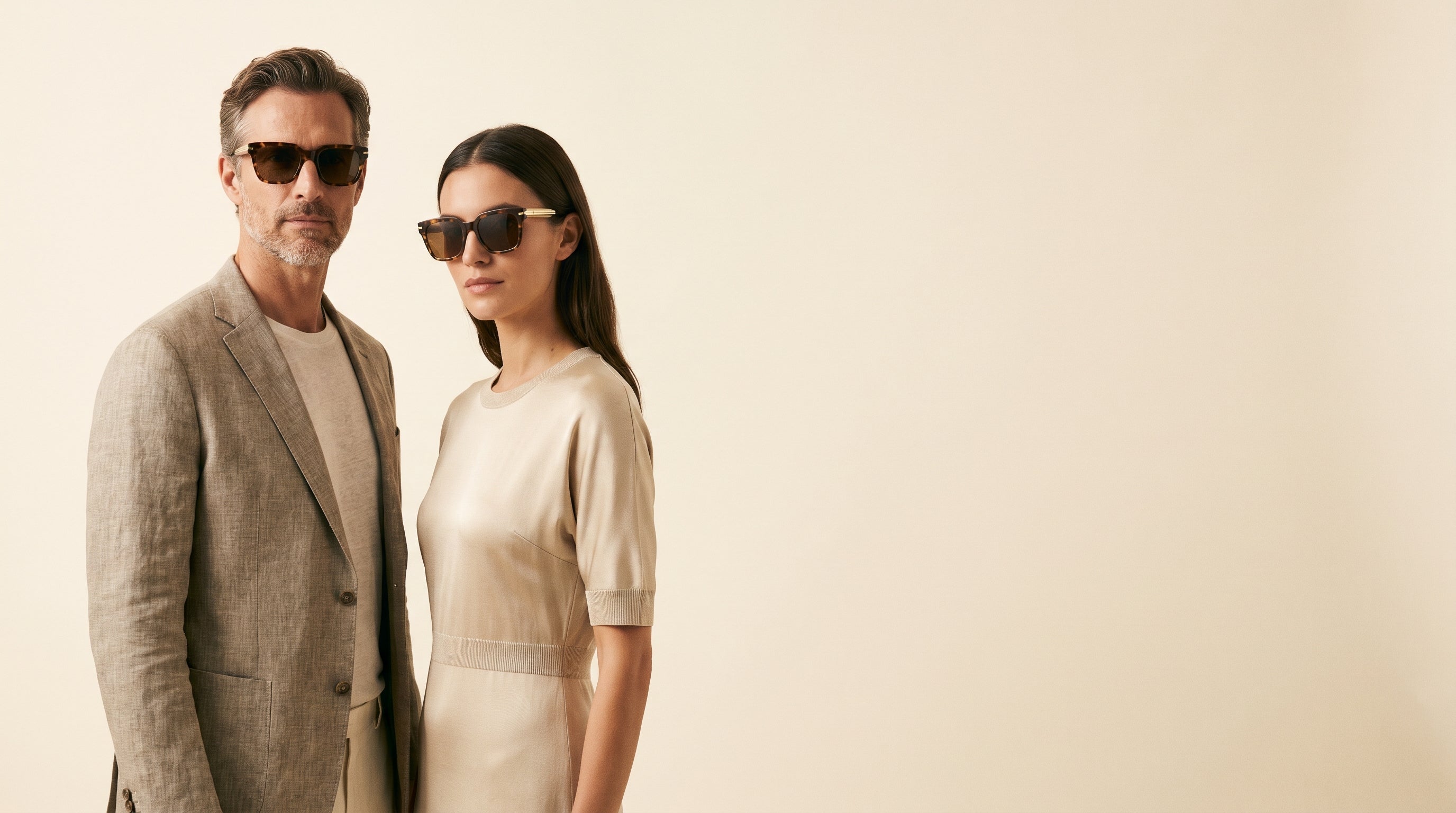 D. Carrera hero desktop — man and woman in sunglasses, cream studio